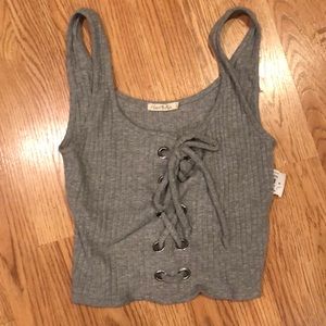 grey cropped tank with grommet detail